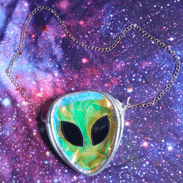 a mini holographic alien bag with alien face on a chain